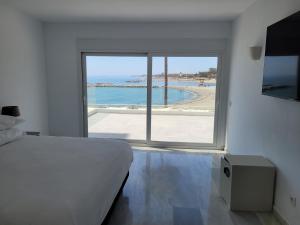 a bedroom with a bed and a view of the ocean at B51 Executive Flats Marbella in Marbella +58 photos