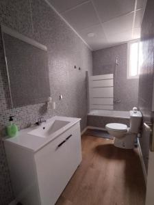 a bathroom with a white sink and a toilet at Apartamento Ceuta in Murcia