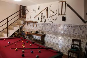 a room with a pool table and a staircase at Casa da Juventude 