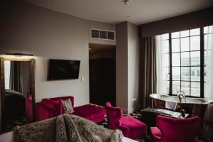 a hotel room with pink furniture and a window at Hotel Gotham in Manchester