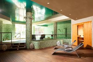 a bathroom with a large mirror and a chair at Ona Marinas de Nerja Spa Resort in Nerja