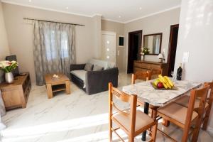 a kitchen and living room with a table and chairs at Amaryllis Seaview House by GuestCorfu in Corfu Town