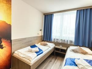 A bed or beds in a room at Hotel Familia