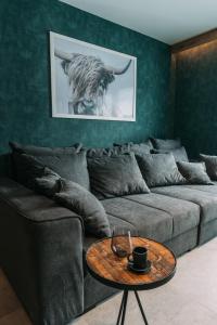 a living room with a couch and a table at Guest House Pohorska Kavarna in Maribor