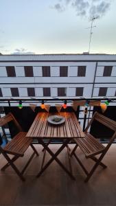 einen Tisch und Stühle auf einem Balkon mit einem Gebäude in der Unterkunft La Black Casa in Zafra