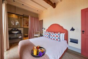 a bedroom with a bed with a bowl of fruit on it at THE PINTA Boutique Hotel in Armamar