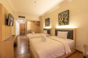 Un ou plusieurs lits dans un hébergement de l'établissement d'Salvatore Boutique Hotel Yogyakarta 17 autres photos