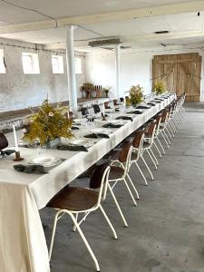 a long long table in a room with chairs at Rusiborek Slow in Murzynowo Kościelne