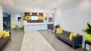 a hospital lobby with two couches and a counter at Tŷ Magor in Magor