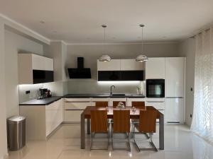 a kitchen with a table and chairs in it at Two Palms in Duće