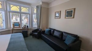 a living room with a couch and a window at Beach Lodge in Bournemouth