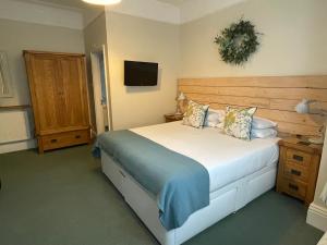 a bedroom with a large bed and a television at Beach Lodge in Bournemouth
