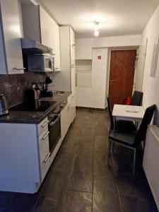 a kitchen with a stove and a table in it at Klosterappartment in Mödling