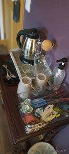 a table with a tea kettle and other items on it at Outlander Boutique B&B King in Cruden Bay