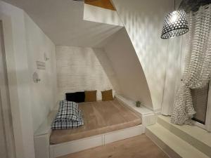 a small room with a bed in the attic at Vienna terraced Apartment in Vienna