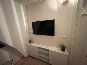 a living room with a television on a wall at Vienna terraced Apartment in Vienna
