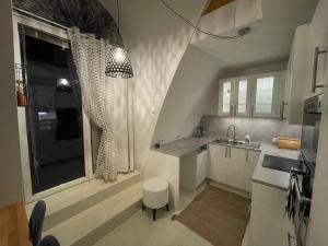 a kitchen with white cabinets and a sink and a window at Vienna terraced Apartment in Vienna