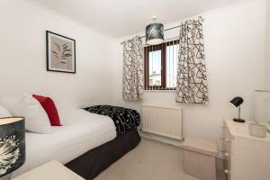 a small bedroom with a bed and a window at Bousfield Crescent in Newton Aycliffe