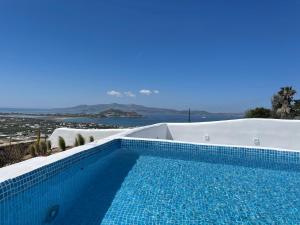 a swimming pool with a view of the ocean at Eye of Naxos in Naxos Chora