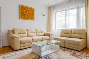 a living room with a couch and a coffee table at Bright 2-BD Top Central Apartment in Sofia