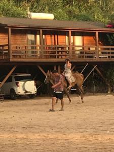 a man and a child riding a horse with a person at Equestrian and Beach Club in Bodrum City