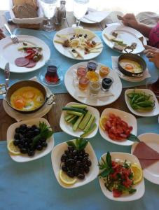a table with many plates of food on it at Equestrian and Beach Club in Bodrum City