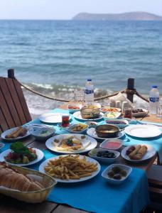 a blue table with plates of food on the beach at Equestrian and Beach Club in Bodrum City