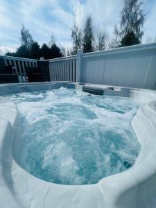 a hot tub covered in snow in a backyard at Evergreen Lodge with Hot Tub in York
