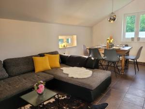 a living room with a couch and a dining room at Familienfreundliche großzügige Ferienwohnung Schlierachwelle zwischen Schliersee und Tegernsee in Hausham