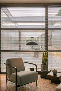 a living room with a chair and a large window at Villa 7 in Perivólia