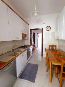 a kitchen with a table and a dining room at Casa Vacanze AlbA in Bari