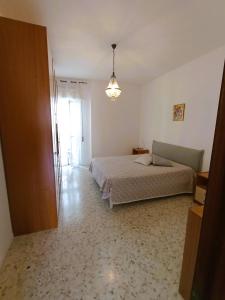 a bedroom with a bed and a large window at Casa Vacanze AlbA in Bari