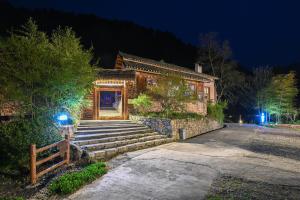 a building with stairs in front of it at night at No.5 Valley Lodge in Zhangjiajie
