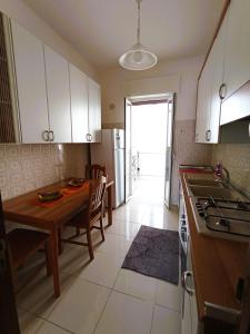 a kitchen with a table and a dining room at Casa Vacanze AlbA in Bari