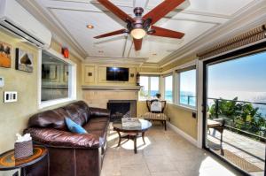 a living room with a couch and a ceiling fan at Villa Bella Mare at the Retreat in Laguna Beach in Laguna Beach