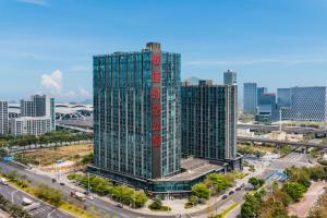 an aerial view of a tall building in a city at April Fair Duplex Apartment Guagnzhou South Railway Station Min Jie Branch in Guangzhou