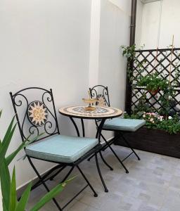 2 sedie e un tavolo su un patio di Casa mia bella a Siracusa