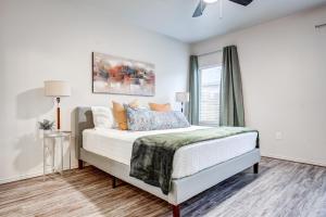 a white bedroom with a bed and a window at Luxury Lubbock Home Retreat near Texas Tech in Lubbock
