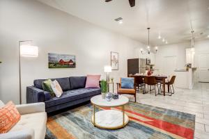 a living room with a couch and a table at Luxury Lubbock Home Retreat near Texas Tech in Lubbock