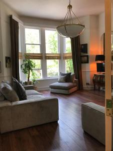 a living room with a couch and a large window at Lakeside View Arts and Craft Apartment in Liverpool