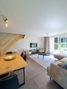 a living room with a couch and a table at Casa Vista Verde in De Panne