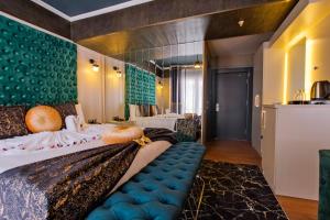 a hotel room with a large bed with a blue couch at MOONDAY HOTEL in Kayseri