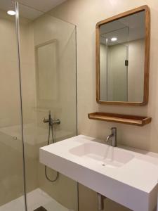 a bathroom with a white sink and a mirror at Habitatges Turístics Riba Pitxot - S'Arenella in Cadaqués