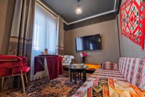 a living room with a couch and a table at MOONDAY HOTEL in Kayseri