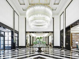 a lobby with a large chandelier and a large hall at Fairmont Amman in Amman