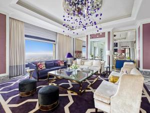 a living room with a chandelier at Fairmont Amman in Amman