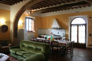 ein Wohnzimmer mit einem Tisch und einer Küche in der Unterkunft Villa Il Poggiarone in Montepulciano