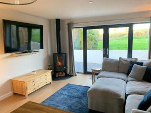 a living room with a couch and a fireplace at Ridgeway View in Pembrokeshire