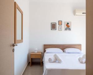 two beds in a room with a door open at Apartment Santa Marina 5 in Asgourou