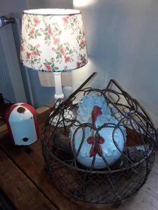 a basket with a lamp on a table next to a lamp at Ferienhaus mit Minibauernhof in Munster im Heidekreis
